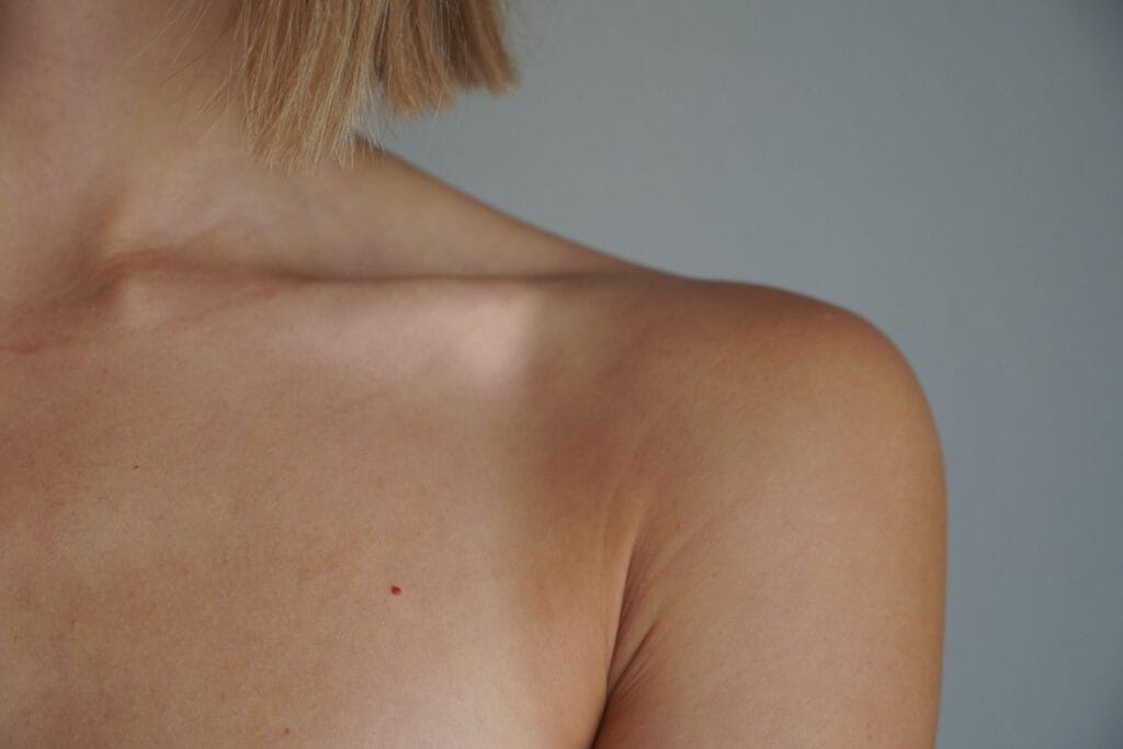 Detailed view of a woman's shoulder and skin tone with natural lighting.