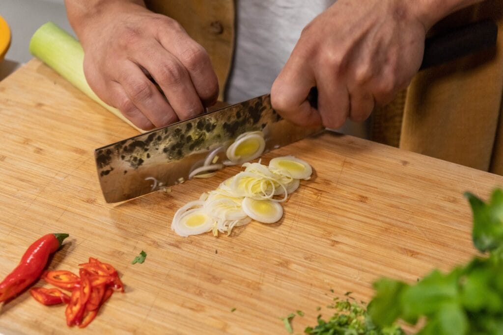 Person schneidet frisches Gemüse für histaminarme Familienrezepte. .